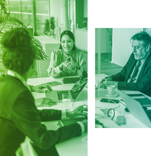 A group of office employees discuss business around a boardroom table. 