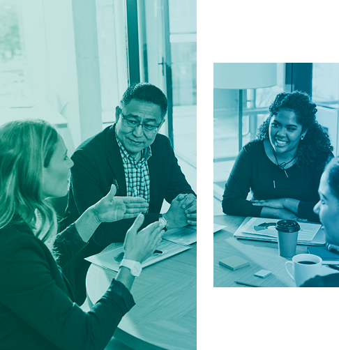 Casual office employees talk around a small coffee table. 