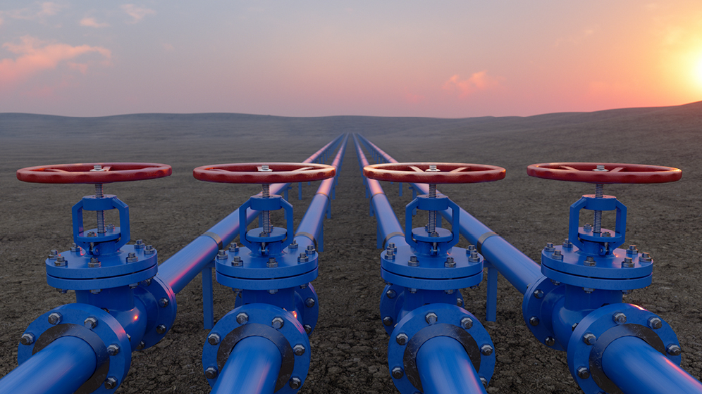 Blue gas pipelines in a dry open landscape.