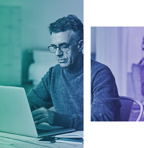 Man sitting at a desk studying his laptop screen. 