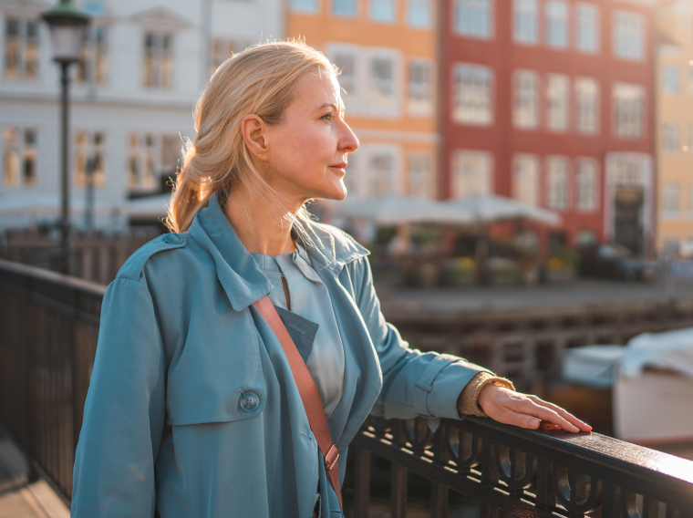 Woman smiling on a sunny bridge
