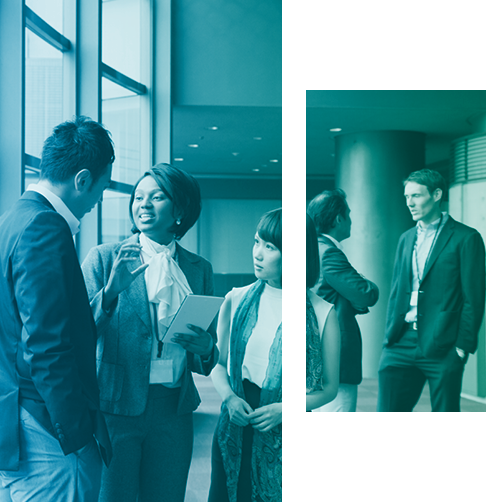 A small group of advisors talk casually in a large office space. 